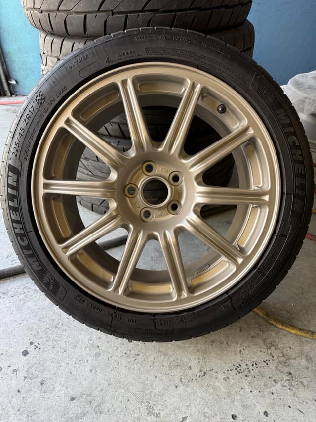 Ten-spoke wheel refinished in gold on a fresh tire