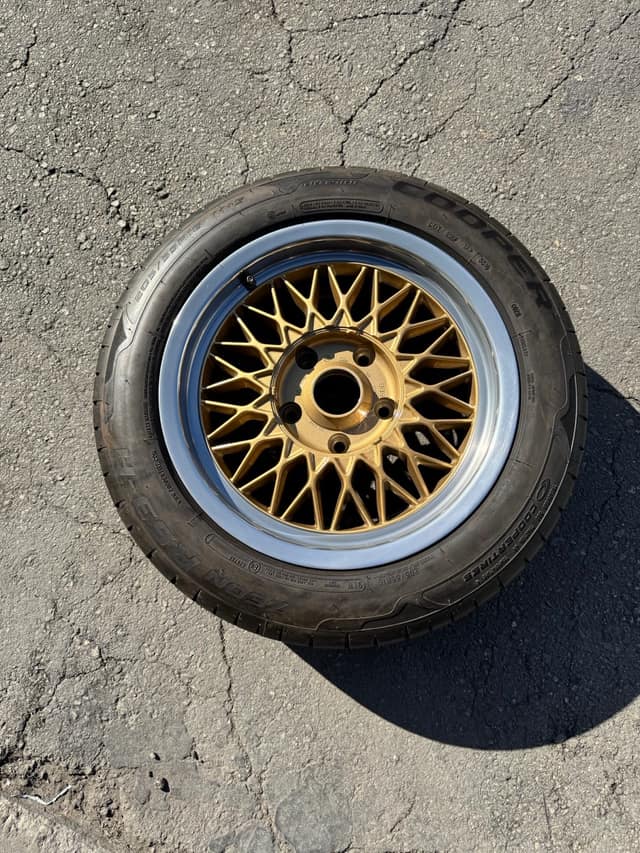 Gold mesh-style wheel refinished and mounted on a tire