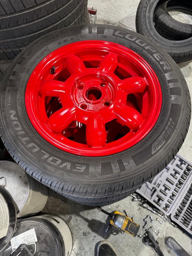 Gloss red powder-coated wheel on a fresh tire